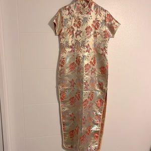 Beautiful gold tone dress made in Viet Nam. Floral designs in reds & blues.